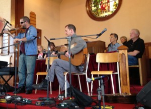 Fiddler and guitarist playing in church.